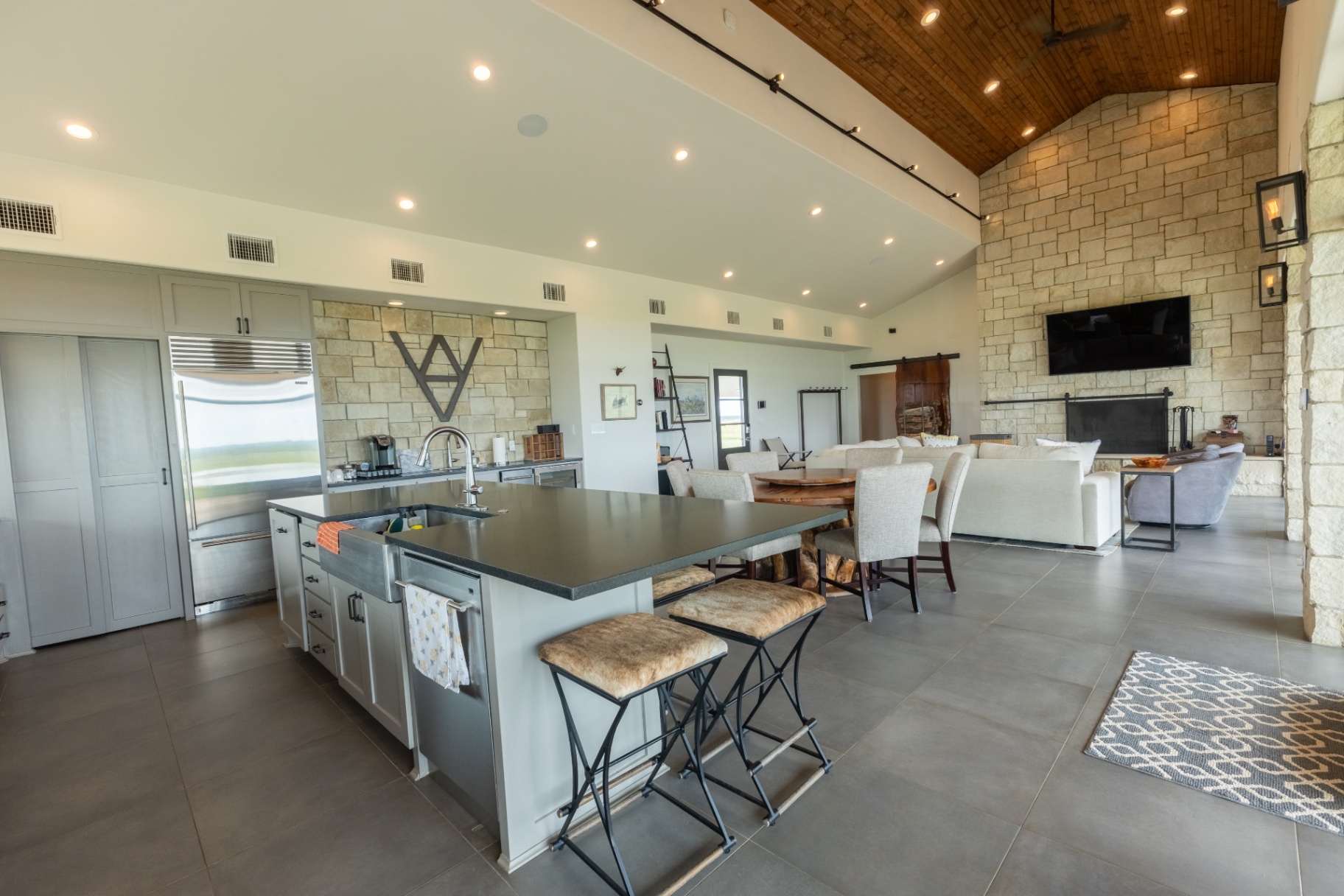 Guest House kitchen with bar stools and open dining — Trinity Valley Ranch Deer, Coleman Texas