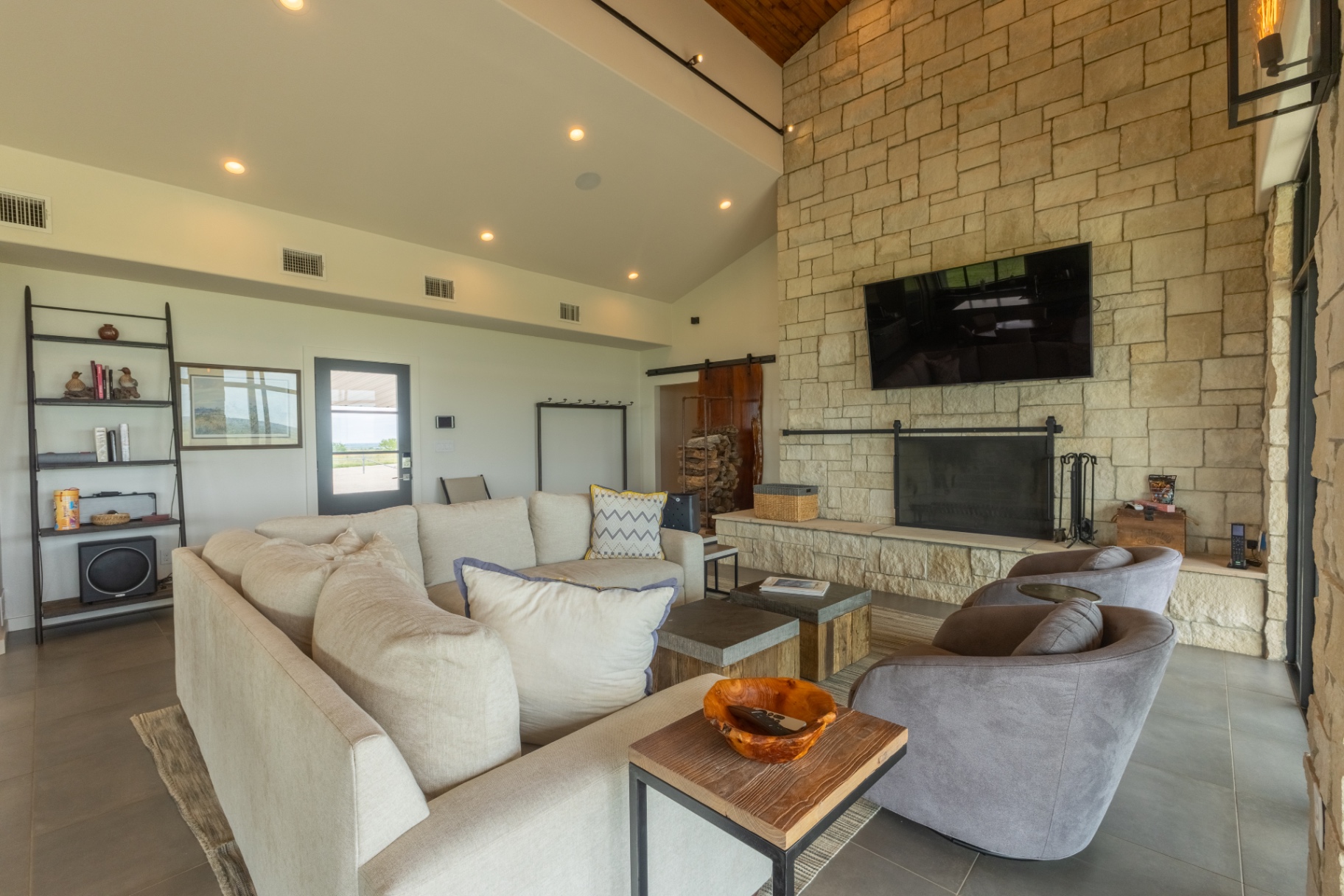 Guest House living area with sectional seating and mounted TV — Trinity Valley Ranch Deer, Coleman Texas