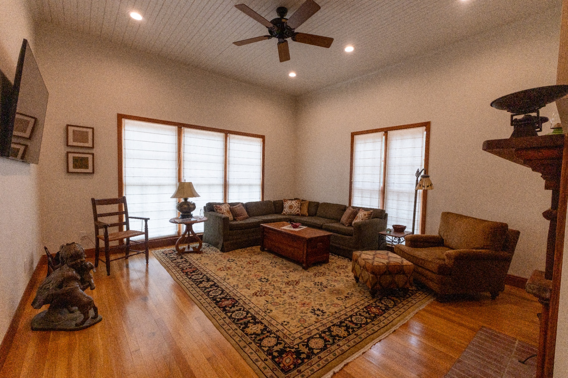 Farm House living room with sectional sofa, vaulted ceiling, and rug — Trinity Valley Ranch Deer, Coleman Texas