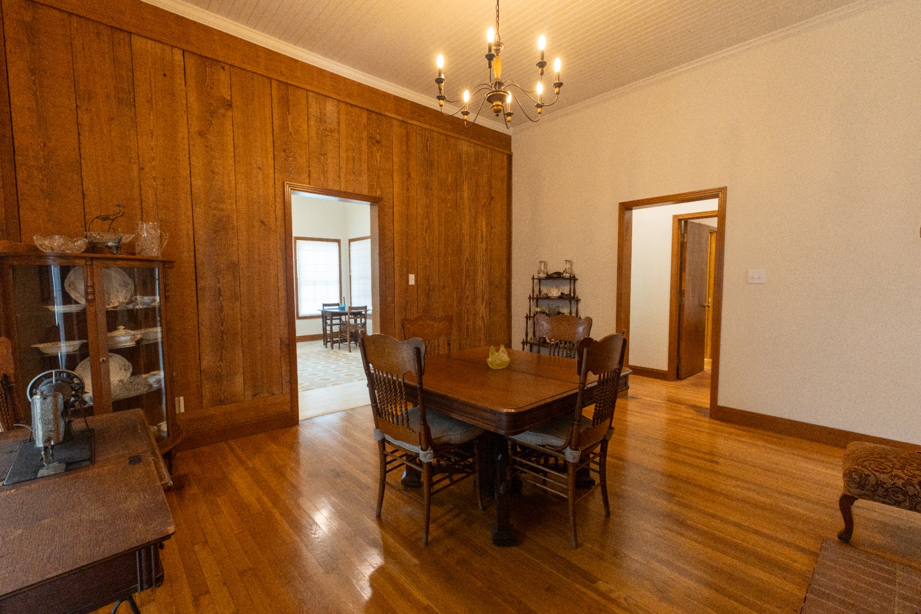 Farm House dining room with original wood paneling opening to the parlor — Trinity Valley Ranch Deer, Coleman Texas