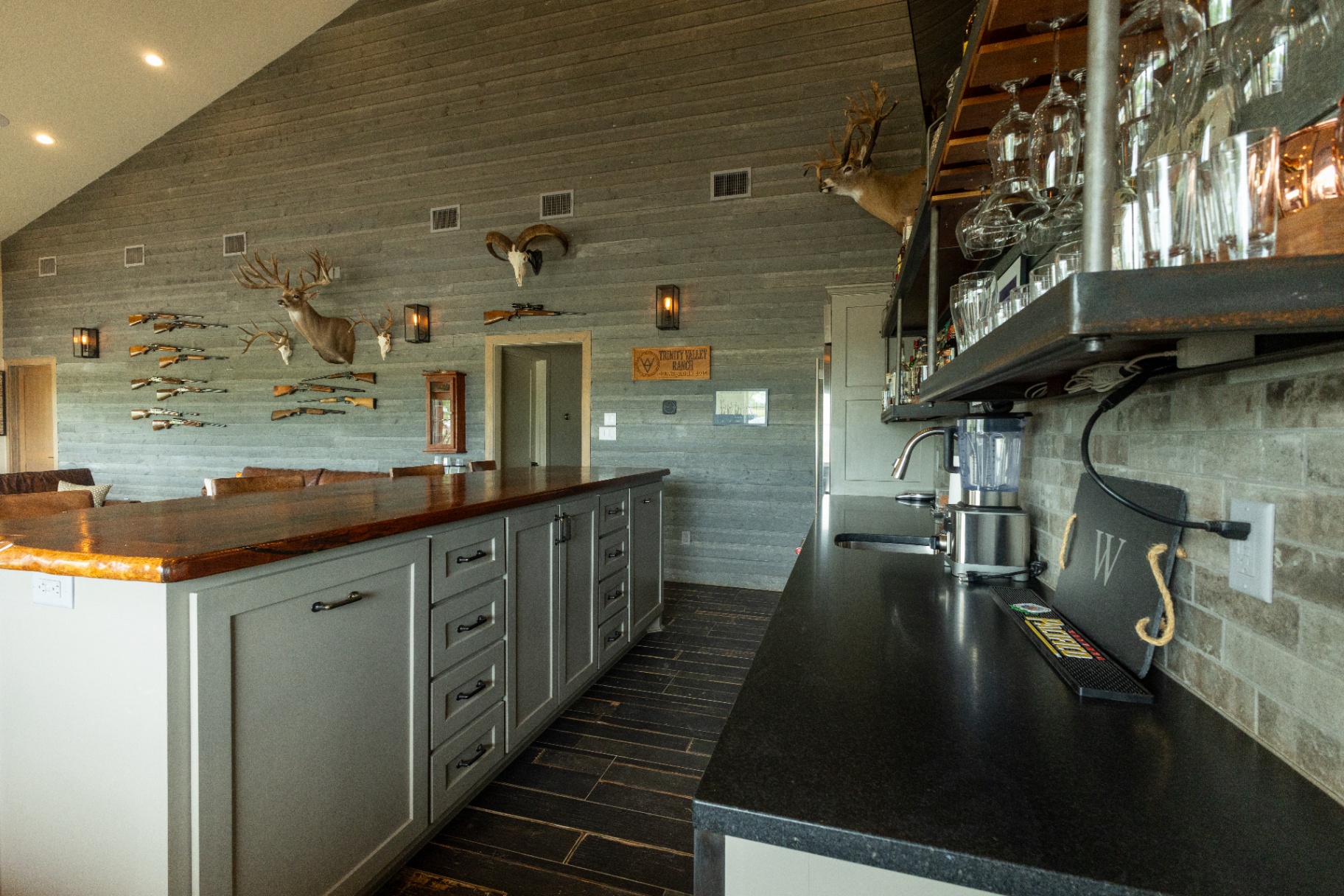Saloon bar island with rifle wall backdrop — Trinity Valley Ranch Deer, Coleman Texas